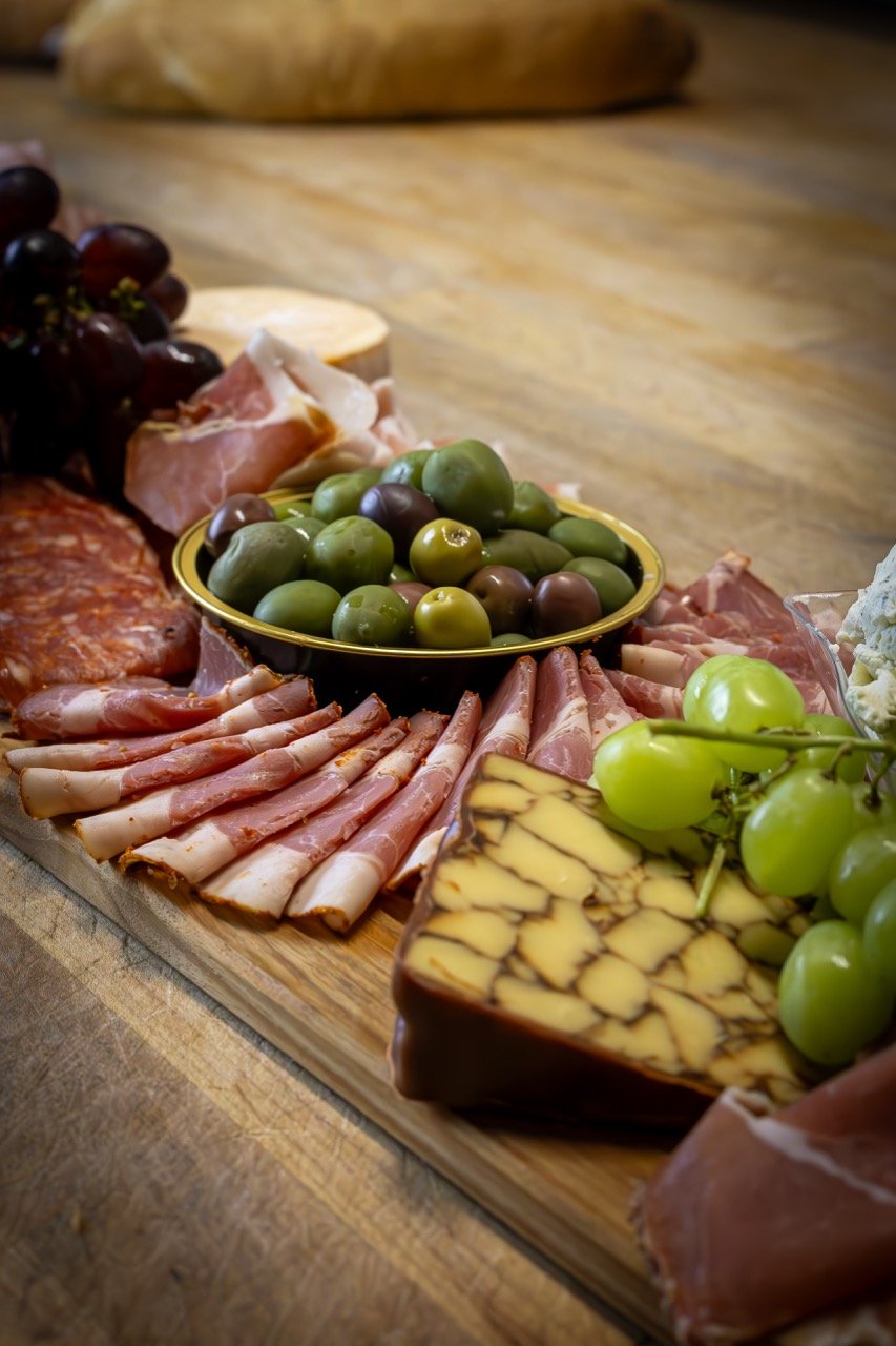 A rustic charcuterie board with wine.